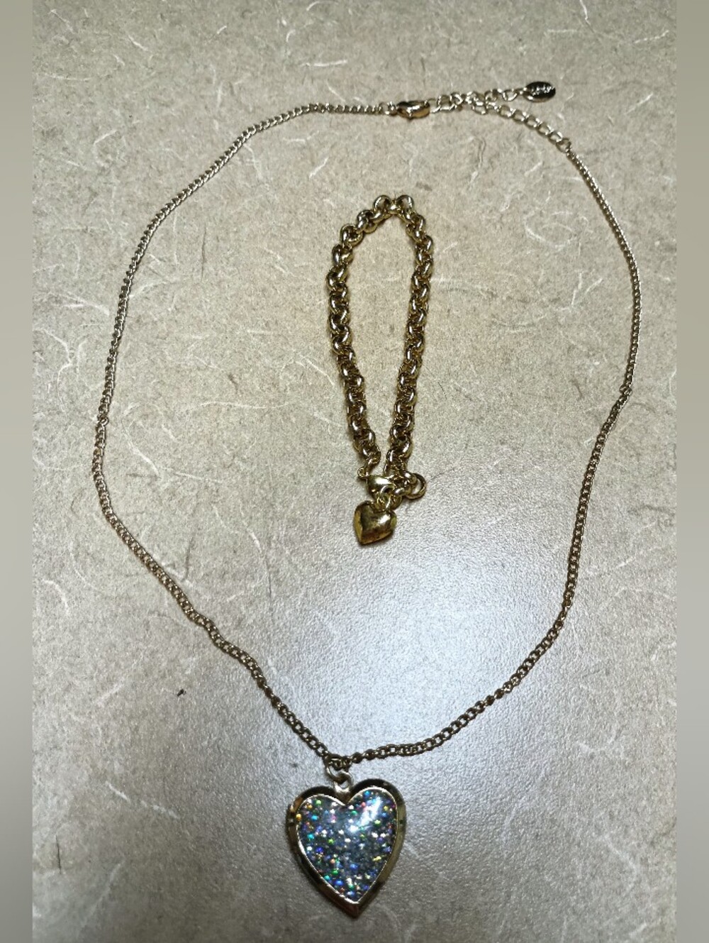 gold toned silver glitter locket with matching heart bracelet from Claires
